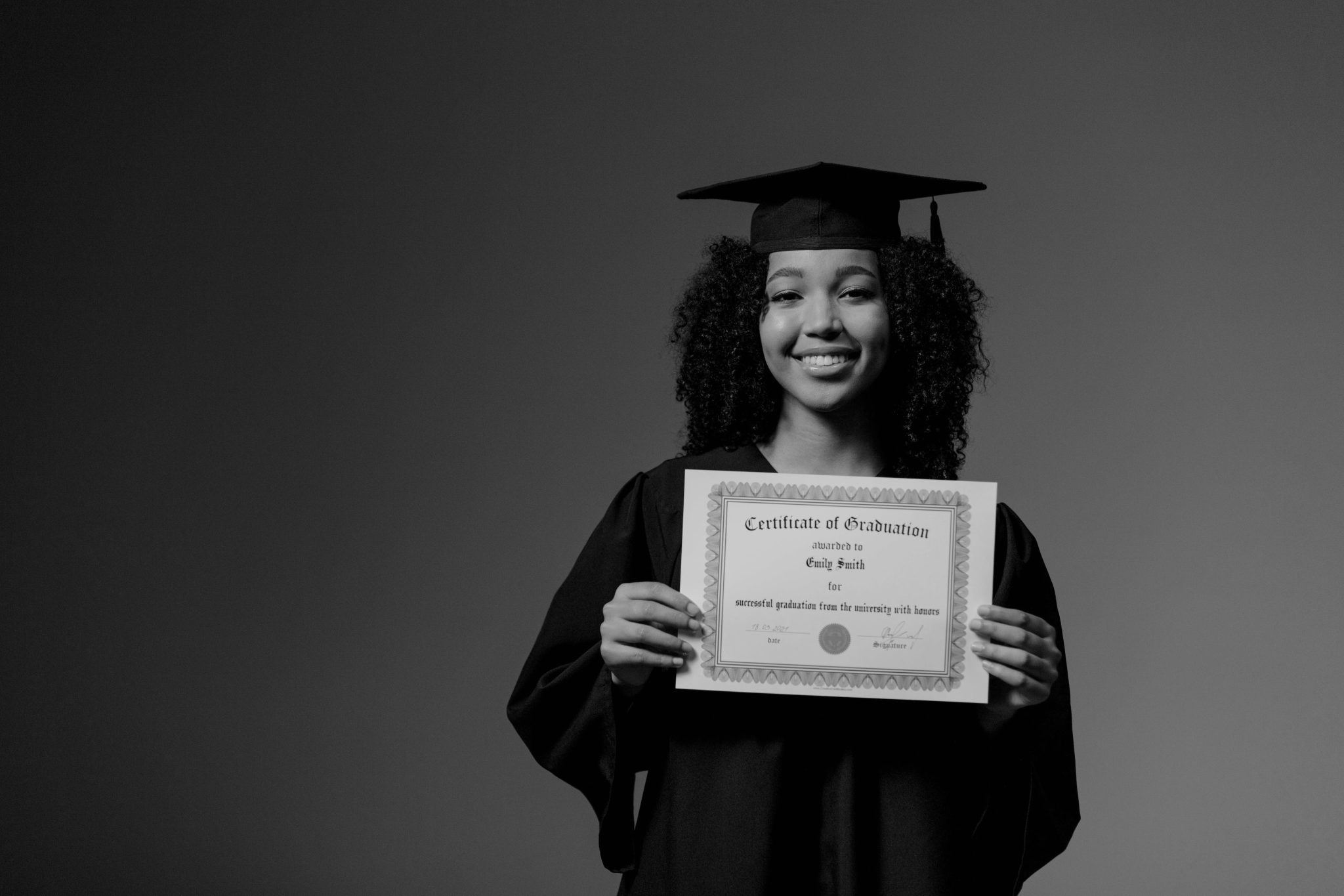 young adult standing with her graduation certificate to illustrate the struggles faced by young adults in South Africa